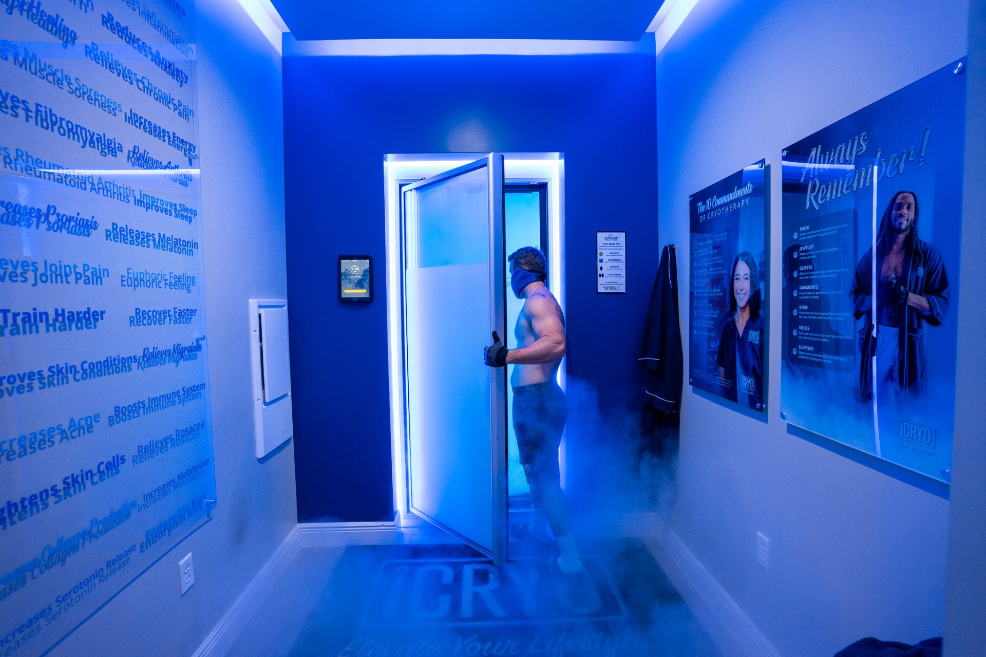 Client entering the whole body cryotherapy chamber at iCRYO Grosse Pointe