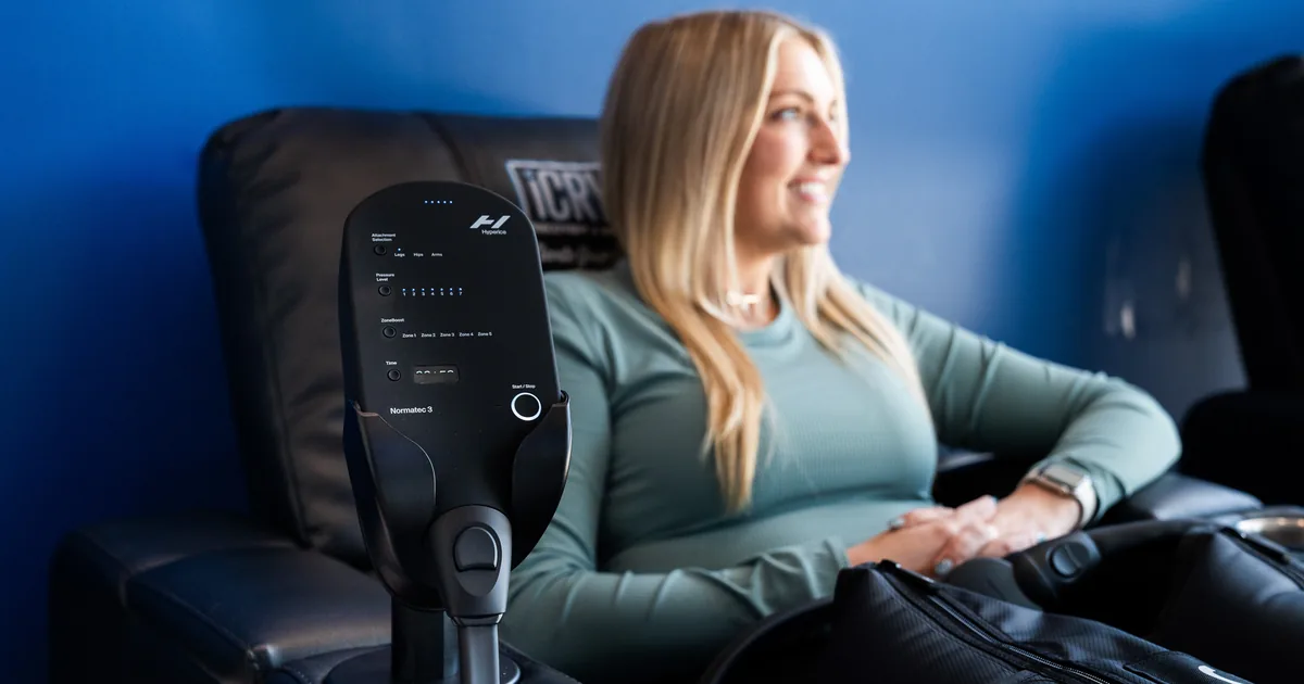 Runner relaxing during compression therapy for recovery at iCRYO Grosse Pointe