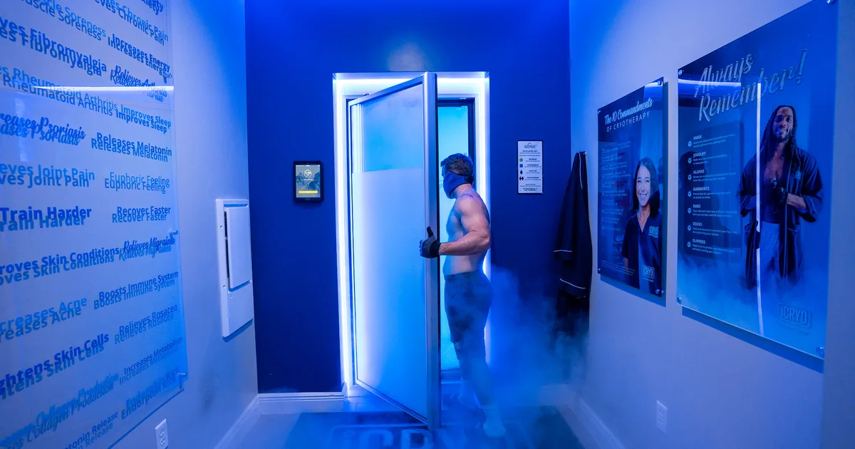 Client in a whole-body cryotherapy chamber with cold vapor at iCRYO Grosse Pointe, MI